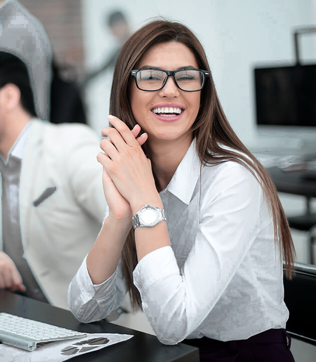 Smiling woman at desk representing Obamacare health insurance